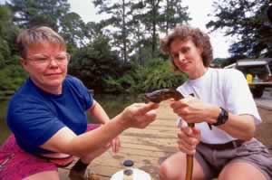 Volunteers at the Chattahoochee Nature Center examine the ponds' alien invader. Photo by Richard T. Bryant. Email richard_t_bryant@mindspring.com.