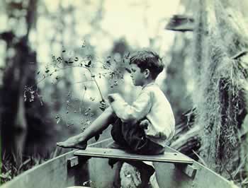 Noah Lee eating huckleberries on Billy's Lake, 1921.